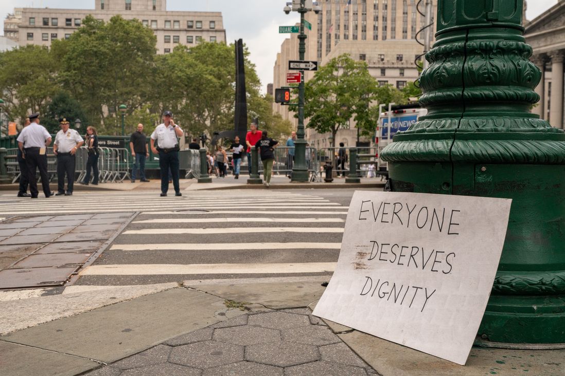 "Everyone Deserve Dignity" sign left at Foley Square<br>
